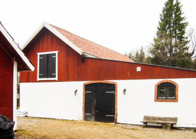 The horse stable on the other side of the garden.