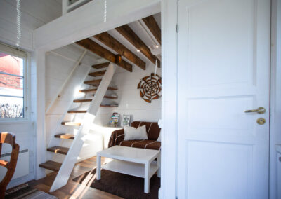 The sofa bed and the stairs to the sleeping loft in the cottage that you can rent.