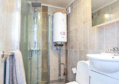 The tiled bathroom with shower in the small cottage.